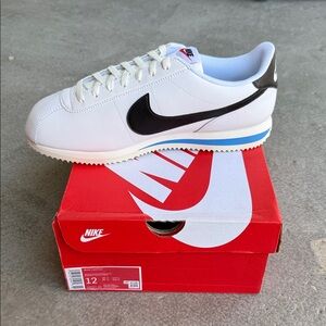 Nike Cortez White Sneakers with Black Swoosh and Blue Stripe